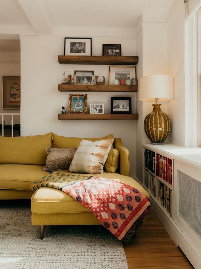 photo of a living room with a candle lit in the background