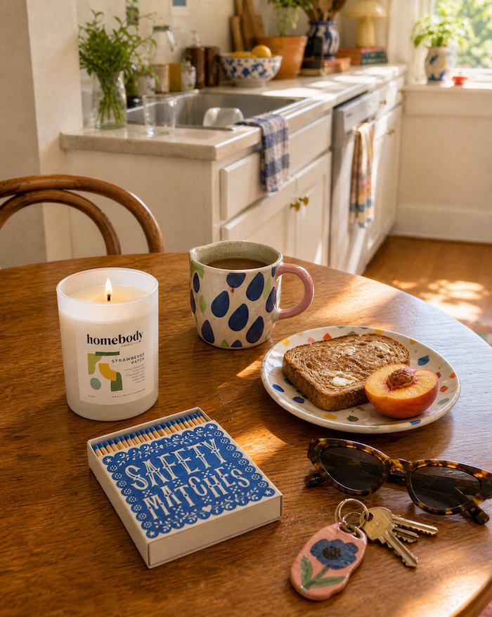 Homebody Candle Co candle on a table with the words 